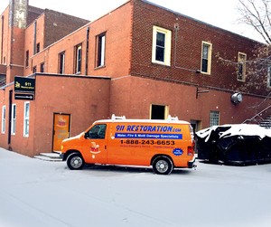 Water Damage Restoration Van At Snowy Civic Job Site