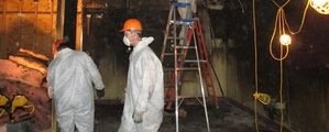 Technicians In Flooded Garage Conducting Renovations